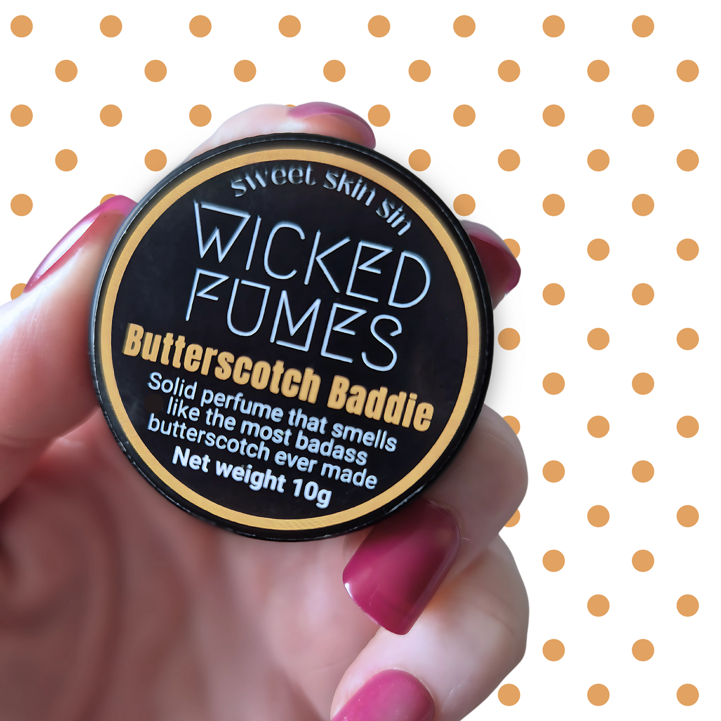 hand holding butterscotch baddie perfume tin