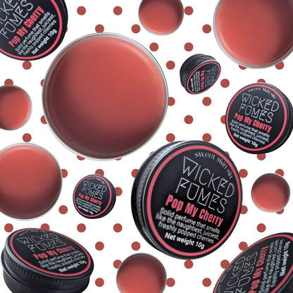 bunch of pop my cherry tins floating against cherry coloured polka dots